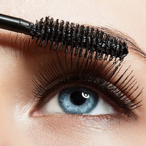 Close-up of make-up blue eye with long lashes with black mascara